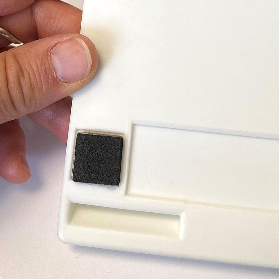 Magnetisk pennh&aring;llare f&ouml;r 4 pennor, vit plast med 4 magneter p&aring; baksidan och sj&auml;lvh&auml;ftande dynor